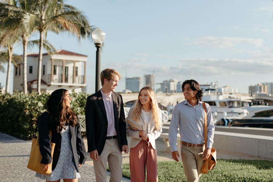master of business administration mba students walk near the intercoastal waterway in 西<a href='http://8y4.oriphotography.net'>推荐全球最大网赌正规平台欢迎您</a>.